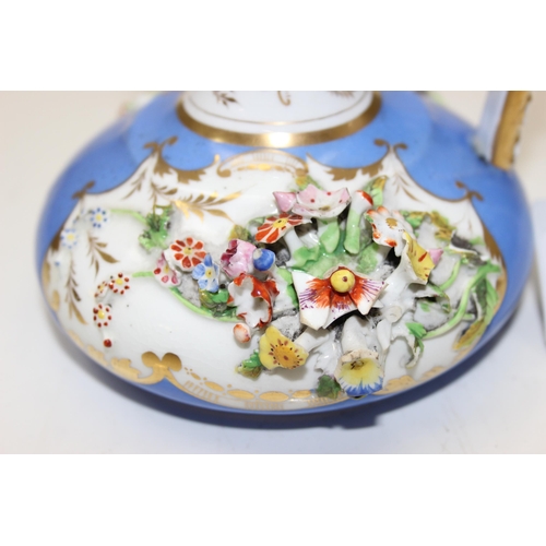 1647 - An early 19th century Bloor Derby porcelain jug encrusted with flowers on a blue ground with gilt hi... 