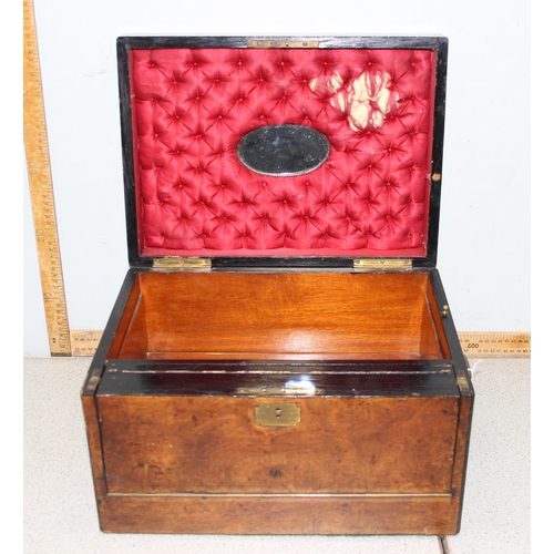 284 - An antique walnut writing and travelling vanity box with various compartments, hidden drawer and cam... 