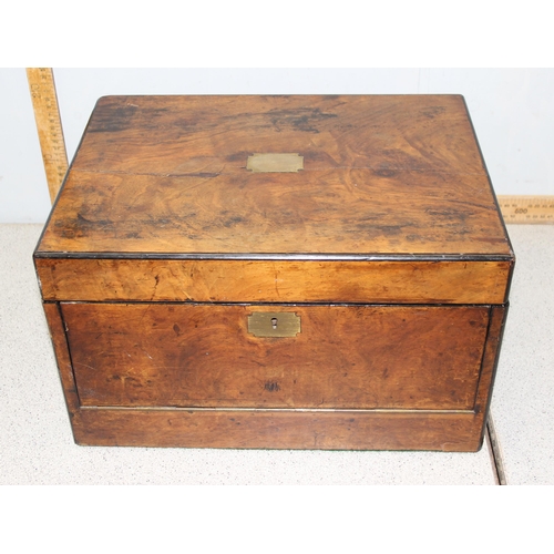 284 - An antique walnut writing and travelling vanity box with various compartments, hidden drawer and cam... 