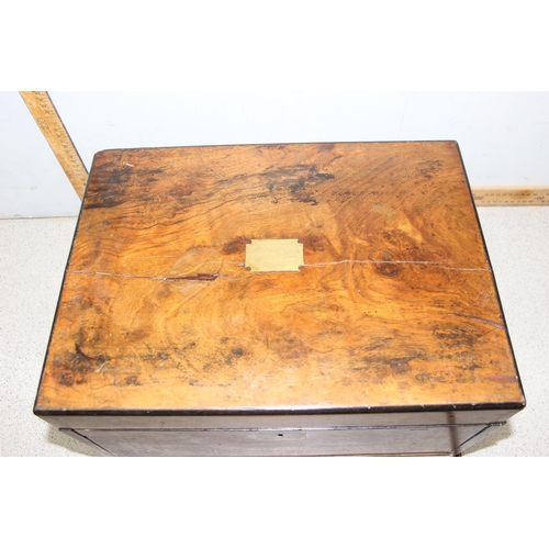 284 - An antique walnut writing and travelling vanity box with various compartments, hidden drawer and cam... 