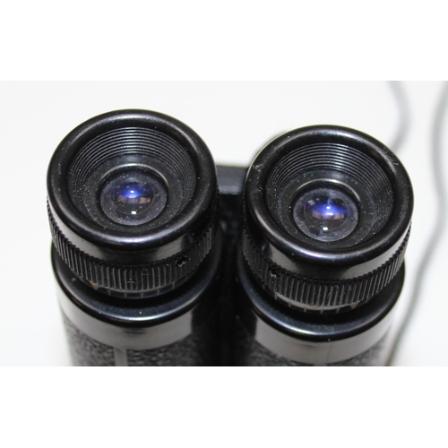 659 - A pair of small Carl Zeiss 8x20 folding binoculars in leather case