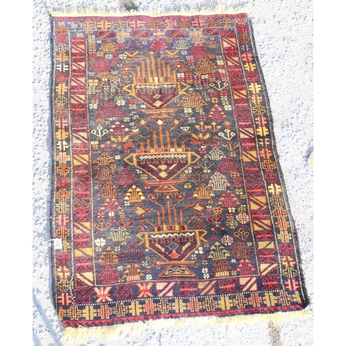 204 - A vintage dark ground rug, approx 140cm x 90cm, made in Pakistan