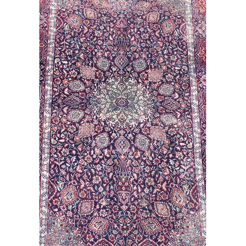 216 - A finely woven vintage Kashan rug of blue ground, approx 160cm x 92cm