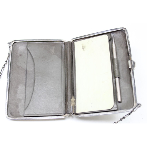 1001 - An early 20th century silver combination coin purse and aide memoire with leather interior and silve... 