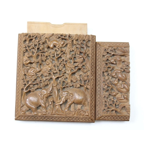 1011 - An unusual antique carved sandalwood card case depicting a variety of animals within a jungle scene,... 