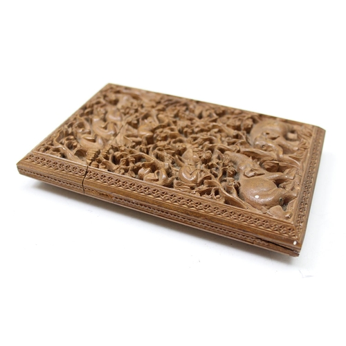 1011 - An unusual antique carved sandalwood card case depicting a variety of animals within a jungle scene,... 