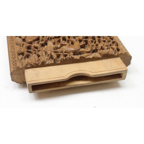 1011 - An unusual antique carved sandalwood card case depicting a variety of animals within a jungle scene,... 