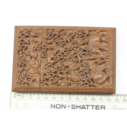 1011 - An unusual antique carved sandalwood card case depicting a variety of animals within a jungle scene,... 