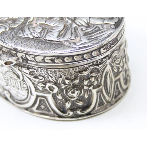 1013 - An antique Dutch 930 silver tobacco or snuff box decorated with an embossed tavern scene, marks to b... 