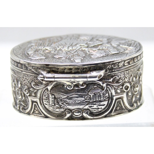 1013 - An antique Dutch 930 silver tobacco or snuff box decorated with an embossed tavern scene, marks to b... 