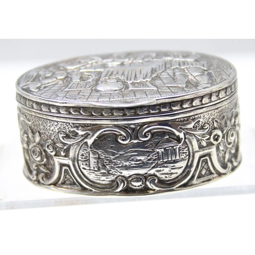 1013 - An antique Dutch 930 silver tobacco or snuff box decorated with an embossed tavern scene, marks to b... 