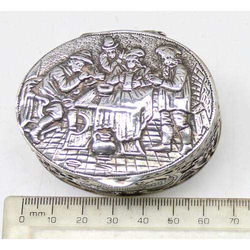 1013 - An antique Dutch 930 silver tobacco or snuff box decorated with an embossed tavern scene, marks to b... 