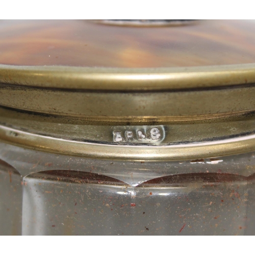 1054 - A silver topped and cut glass jar with planished finish, Birmingham 1901 and another faux tortoisesh... 