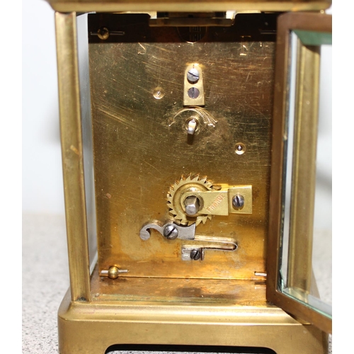 1337 - A vintage French brass cased carriage clock with unusual silvered face, mechanical movement with key