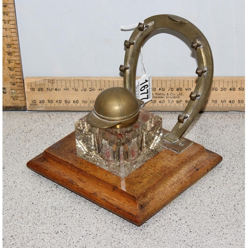 1677 - A 19th century inkwell and pen stand formed as a horse shoe and the inkwell lid formed as a jockey c... 