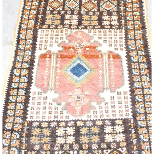 217 - Large orange ground rug with geometric gul border, approx 145cm x 260cm