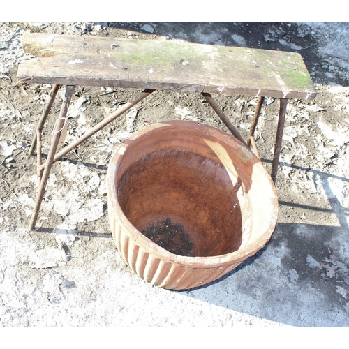 340 - Ribbed terracotta garden pot and a vintage sawhorse