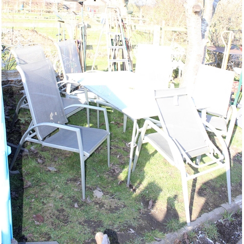 341 - Aluminium framed glass top garden table with 6 folding chairs. approx width of table 153cm