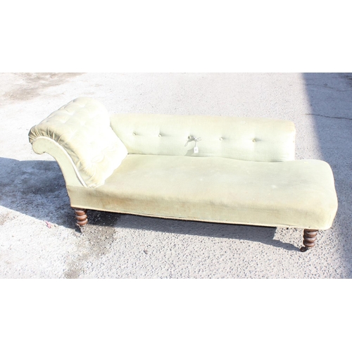 96 - A Victorian button back chaises longue with turned mahogany legs and light green upholstery