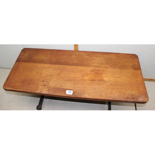 138 - A retro wooden coffee table on wheels, unmarked, approx 90cm wide