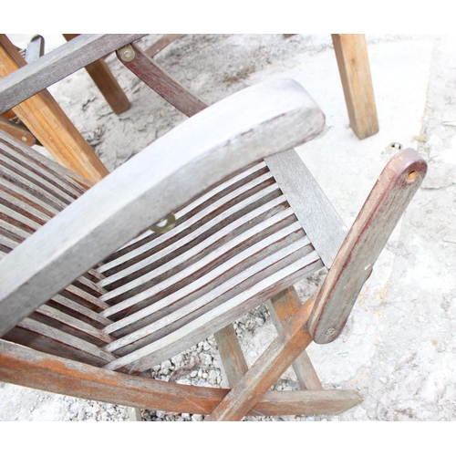 338 - Round slated teak garden table and 3 teak folding chairs. approx diameter 120cm