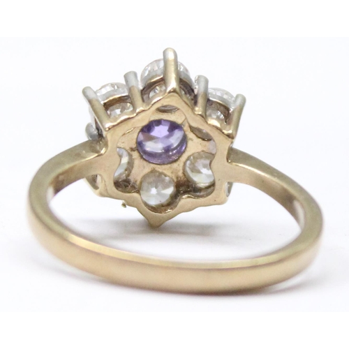 1157 - A 9ct gold floral cluster ring set with 5 white stones set round a central amethyst, approx size Q, ... 