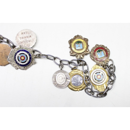 1065 - A large chain housing 25 silver plated and other enamelled fobs and medals, mainly Archery related, ... 