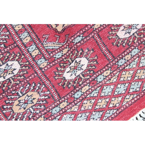 220 - A vintage red ground runner rug with thick pile, approx 180cm x 68cm