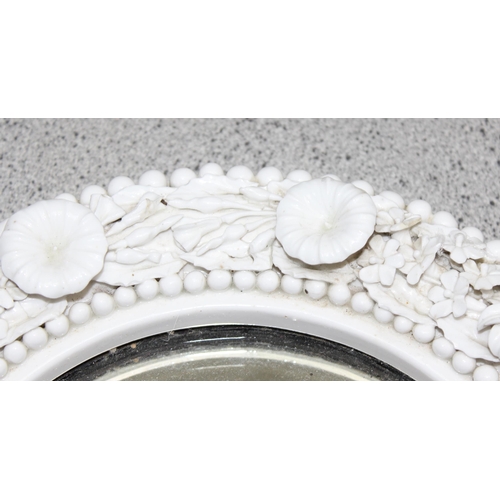 408 - An antique white porcelain framed wall mirror decorated with encrusted flowers, possibly Belleek but... 