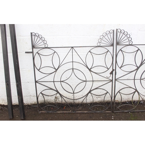 305 - A pair of heavy duty decorative wrought iron garden gates with posts, each approx 116cm wide