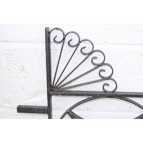 305 - A pair of heavy duty decorative wrought iron garden gates with posts, each approx 116cm wide