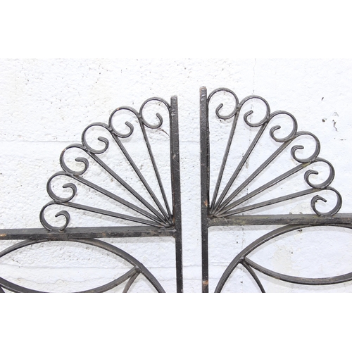 305 - A pair of heavy duty decorative wrought iron garden gates with posts, each approx 116cm wide