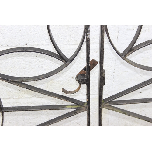 305 - A pair of heavy duty decorative wrought iron garden gates with posts, each approx 116cm wide