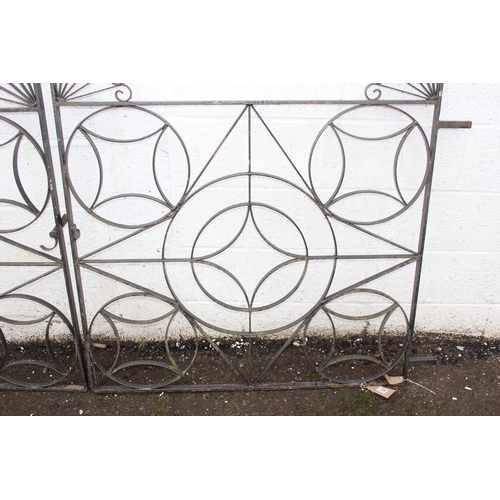 305 - A pair of heavy duty decorative wrought iron garden gates with posts, each approx 116cm wide