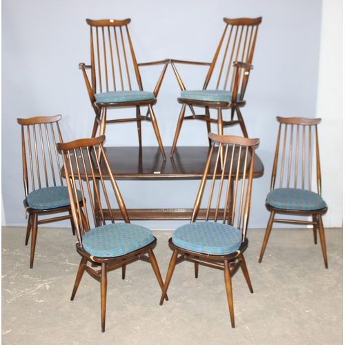 11 - A set of 6 Ercol Goldsmith pattern retro dining chairs with blue and gold labels and a matching dini... 