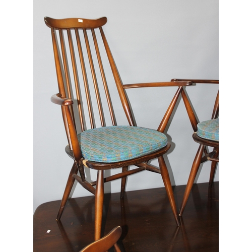 11 - A set of 6 Ercol Goldsmith pattern retro dining chairs with blue and gold labels and a matching dini... 