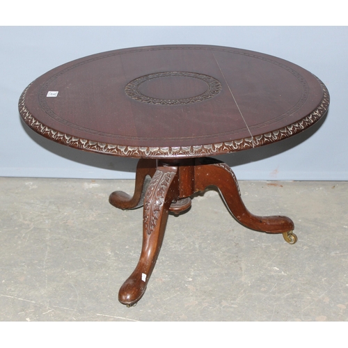 35 - A 20th century mahogany low table with carved details, approx 80cm in diameter