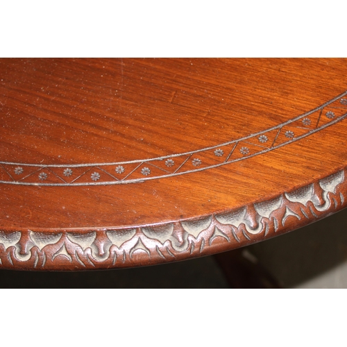 35 - A 20th century mahogany low table with carved details, approx 80cm in diameter