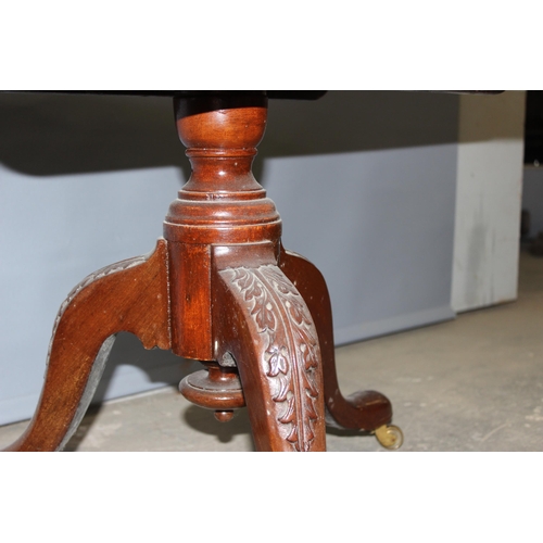 35 - A 20th century mahogany low table with carved details, approx 80cm in diameter