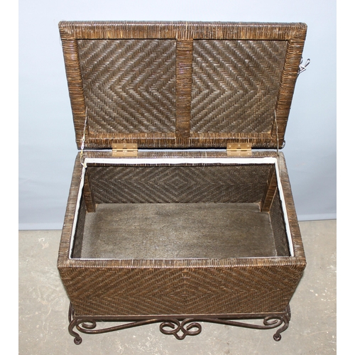 46 - A woven rattan storage box with wrought iron stand, approx 58cm wide