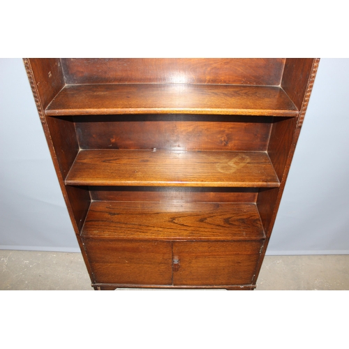 49 - A vintage Art Deco period oak bookcase with cupboard, approx 74cm wide