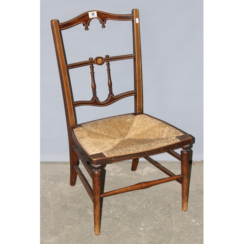 50 - An early 20th century bedroom chair with strung inlay and rush seat