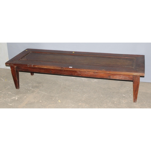 53 - An extremely large long low table formed from an antique wooden door, approx 192cm x 70cm