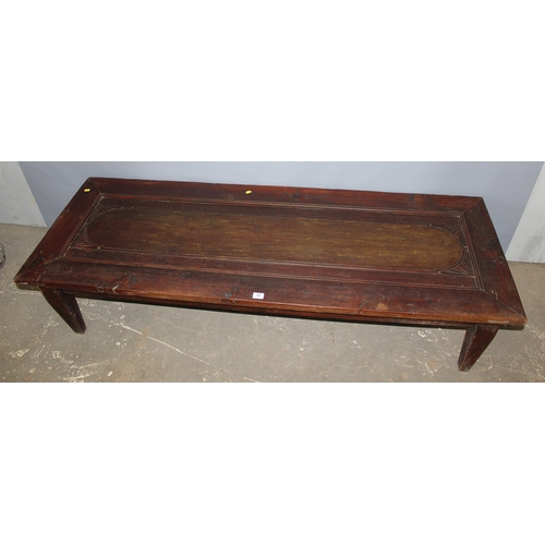 53 - An extremely large long low table formed from an antique wooden door, approx 192cm x 70cm