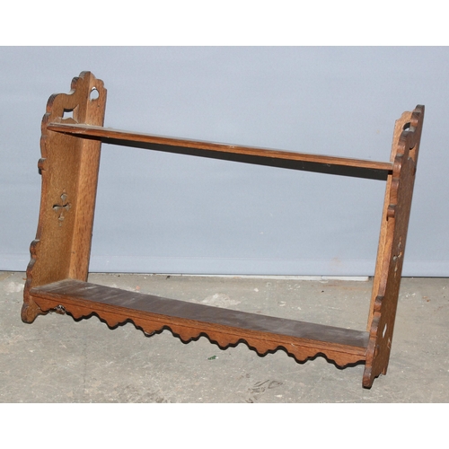 57 - A small antique oak wall shelf with fretwork ends, approx 60cm wide