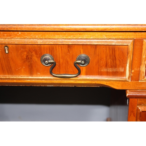 58 - An antique style leather topped pedestal desk, approx 120cm wide