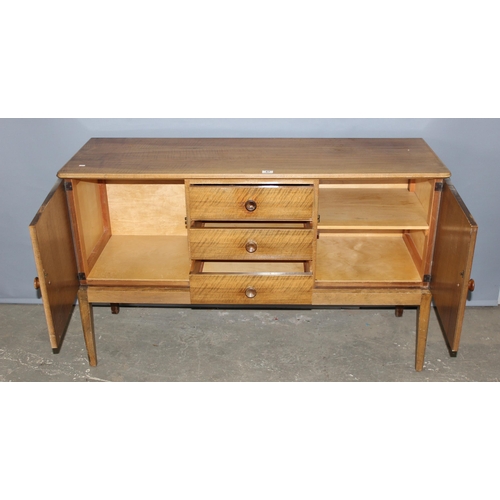 67 - A retro Gordon Russell sideboard, a bank of 3 drawers flanked by 2 cupboards, label verso, approx 14... 