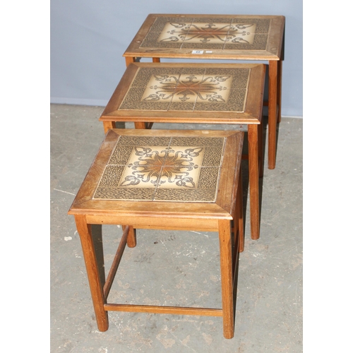 68 - A retro tile topped nest of table, the largest approx 55cm wide