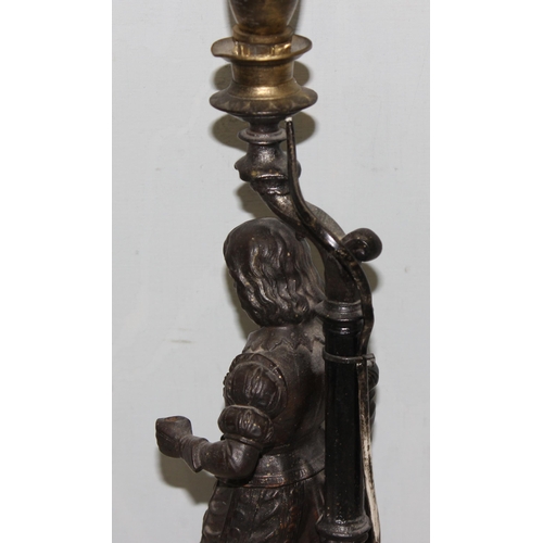 233 - An early 20th century bronzed spelter table lamp formed as a 17th century male figure, with glass sh... 