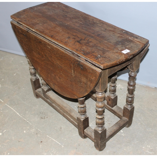 72 - An 18th century oak drop leaf table with single drawer and turned legs